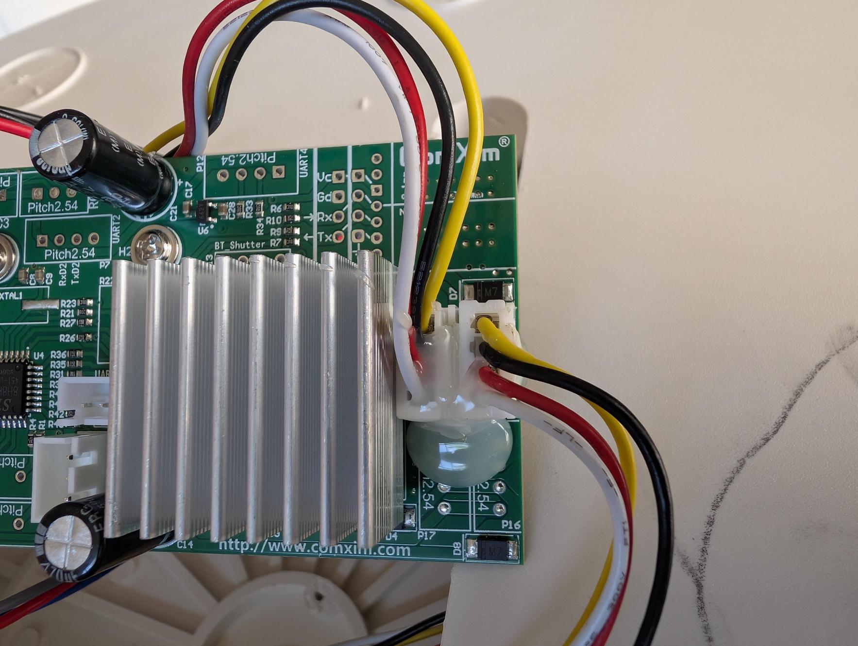 June 23: Board right side. Large aluminum heatsink covers the motor driver IC. UART4 test pads (Vc, Gd, Rx, Tx) visible upper-right.